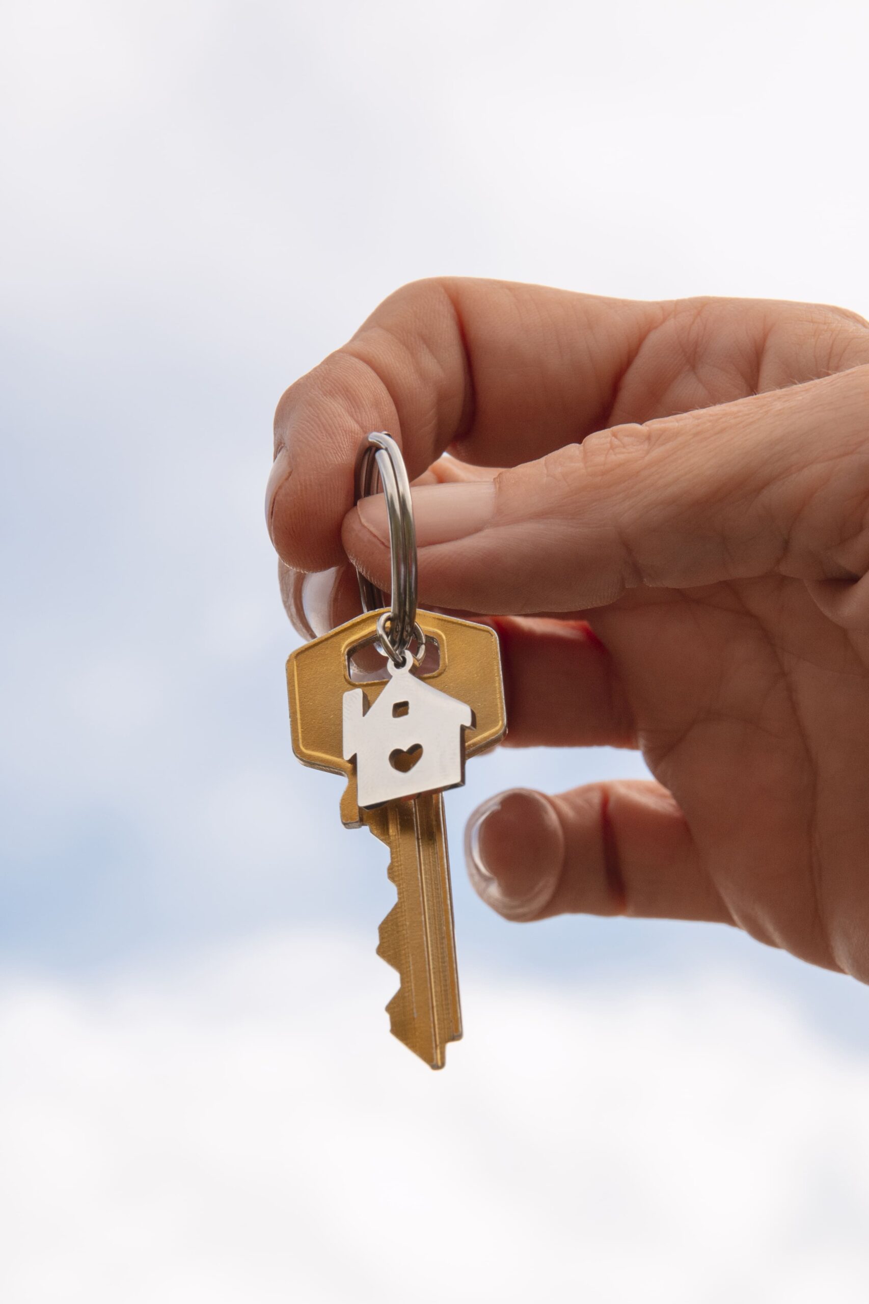 hand-holding-key-outdoors